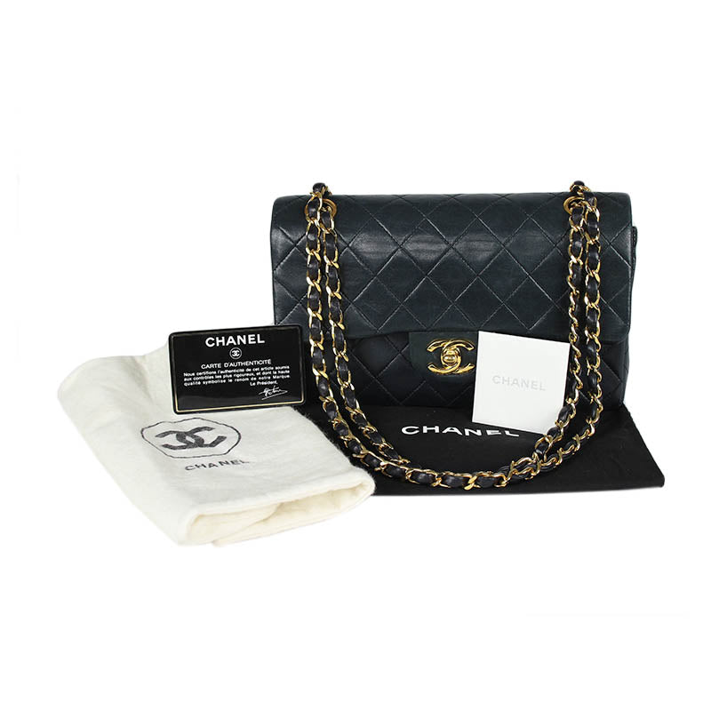 Chanel small classic navy double flap with gold tone hardware and double chain.