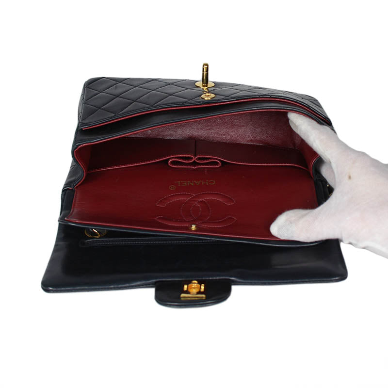 Chanel small classic navy double flap with gold tone hardware and double chain.